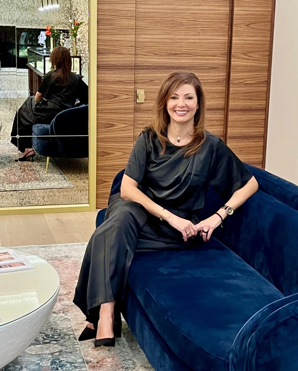 Madona Nemr, founder of MAD Design Interiors, seated in a Halifax interior she designed